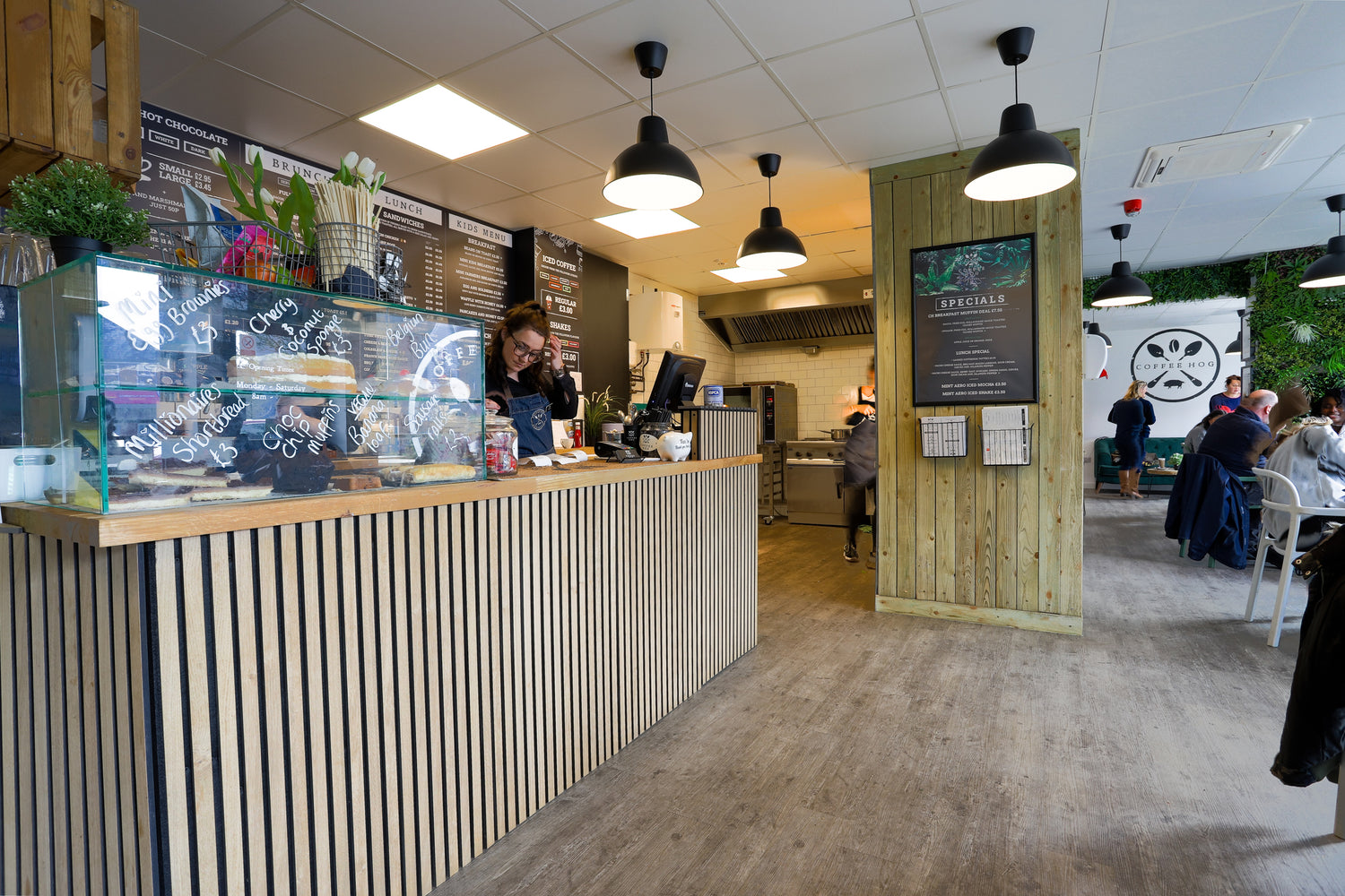 The inside of Coffee Hog cafe with customers enjoying their meals in the background